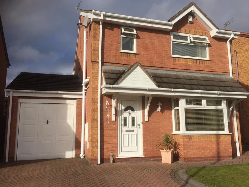 New white UPVC guttering fully installed on a Merseyside detached home — completed by Sefton Roofing